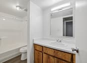 Thumbnail 14 of 26 - A bathroom with a white sink and a mirror.