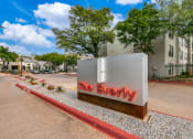 Thumbnail 38 of 40 - a sign that says the everyday in front of an apartment building
