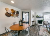 Thumbnail 4 of 40 - a living room with a dining room table and a fireplace