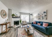 Thumbnail 8 of 40 - the living room of an apartment with a blue couch and a fireplace