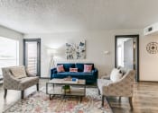 Thumbnail 9 of 40 - a living room with a blue couch and two chairs