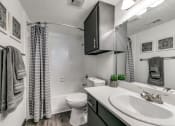 Thumbnail 12 of 40 - a bathroom with a sink and a toilet and a shower