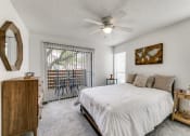 Thumbnail 11 of 40 - a bedroom with a bed and a ceiling fan