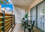 Thumbnail 15 of 40 - a patio with a table and chairs on a balcony