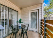 Thumbnail 14 of 40 - a patio with a table and chairs and a sliding glass door