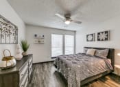 Thumbnail 10 of 40 - a bedroom with a bed and a ceiling fan
