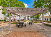 Thumbnail 29 of 40 - a picnic area with benches and a pergola