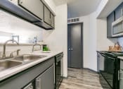 Thumbnail 2 of 40 - the kitchen of our apartments has a stainless steel counter top and a sink