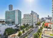 Thumbnail 3 of 66 - an aerial view of a city street with tall buildings and palm trees