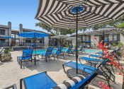Thumbnail 16 of 33 - our patio is full of chairs and umbrellas and a pool