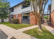 Thumbnail 19 of 33 - the front of a house with a sidewalk and trees