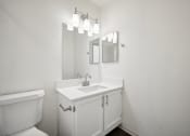 Thumbnail 11 of 33 - a bathroom with a sink and a mirror and a toilet