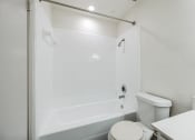 Thumbnail 10 of 33 - a bathroom with a tub and a toilet and a sink