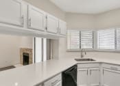 Thumbnail 3 of 33 - a kitchen with white cabinets and a sink and a window