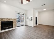 Thumbnail 7 of 33 - a living room with a fireplace and a door to a balcony