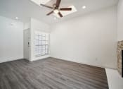 Thumbnail 4 of 33 - an empty living room with a ceiling fan and a fireplace