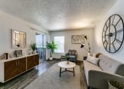 Thumbnail 6 of 30 - a living room with a couch and a clock on the wall