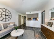 Thumbnail 5 of 30 - an open living room and kitchen with a large clock on the wall