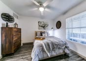 Thumbnail 9 of 30 - a bedroom with a bed and a ceiling fan