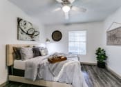 Thumbnail 8 of 30 - an attic bedroom with a bed and a ceiling fan