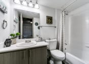 Thumbnail 10 of 30 - a bathroom with a sink toilet and a shower