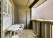 Thumbnail 11 of 30 - a balcony with a table and chairs and a door
