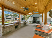 Thumbnail 19 of 30 - a covered patio with a bar and a pool