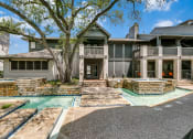 Thumbnail 22 of 30 - a house with a swimming pool and a tree in front of it