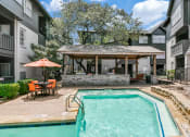 Thumbnail 23 of 30 - our apartments have a swimming pool and a patio with a table and chairs