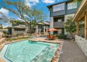 Thumbnail 28 of 30 - a swimming pool with an umbrella in front of a house