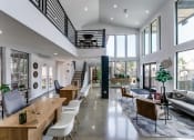 Thumbnail 18 of 30 - the living room and dining area of a house with large glass windows and a staircase