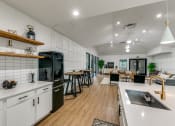 Thumbnail 14 of 29 - an open kitchen and living room with a dining area and a kitchen counter with a
