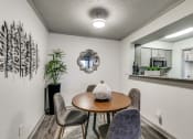 Thumbnail 4 of 29 - a dining room area with a table and chairs and a mirror