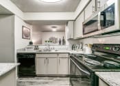 Thumbnail 2 of 29 - an updated kitchen with stainless steel appliances and white cabinets