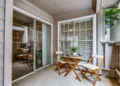 Thumbnail 8 of 29 - a patio with a table and chairs and a sliding glass door
