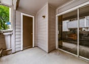 Thumbnail 11 of 29 - the entrance to a home with a patio and a door to the yard