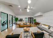 Thumbnail 20 of 29 - a living room with couches and chairs and a rug