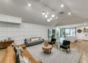 Thumbnail 18 of 29 - a living room with white walls and furniture and a kitchen