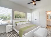 Thumbnail 37 of 65 - a bedroom with a large bed and a ceiling fan