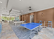 Thumbnail 24 of 33 - a game room with ping pong tables and a pool table