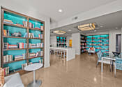 Thumbnail 18 of 33 - a library with tables and chairs and shelves of books