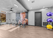 Thumbnail 13 of 33 - A gym with exercise bikes and a large poster on the wall.