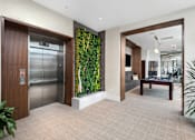 Thumbnail 18 of 25 - A modern office space with a green wall and a wooden door.