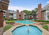 Thumbnail 20 of 42 - A pool with a fountain in the middle of it.