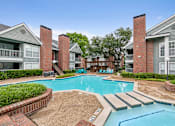 Thumbnail 18 of 42 - A swimming pool surrounded by brick buildings.