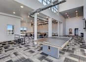 Thumbnail 10 of 23 - a game room with a ping pong table and tables