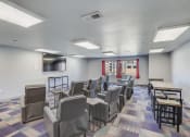 Thumbnail 16 of 23 - a conference room with chairs and tables and a television
