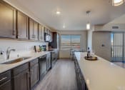 Thumbnail 18 of 23 - a kitchen with stainless steel appliances and a long counter top