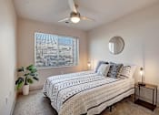 Thumbnail 3 of 23 - a bedroom with a bed and a ceiling fan