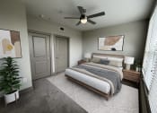 Thumbnail 31 of 33 - a bedroom with a bed and a ceiling fan